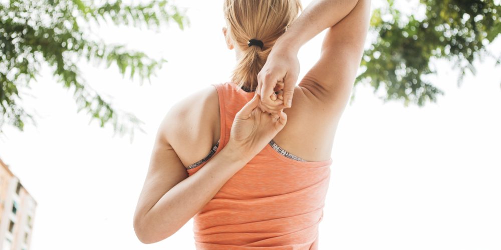 sporty-woman-stretching-urban-environment